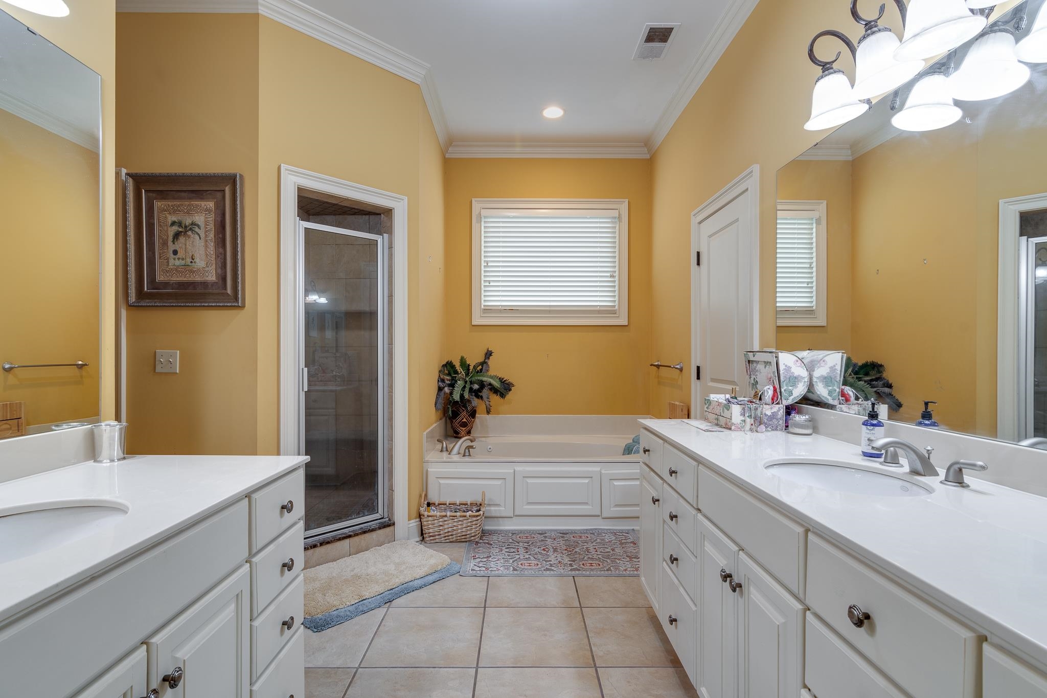 226 North White Station Road Memphis, TN 38117 - Photo 20 of 31 Bathroom with crown molding, tile flooring, vanity, and shower with separate bathtub