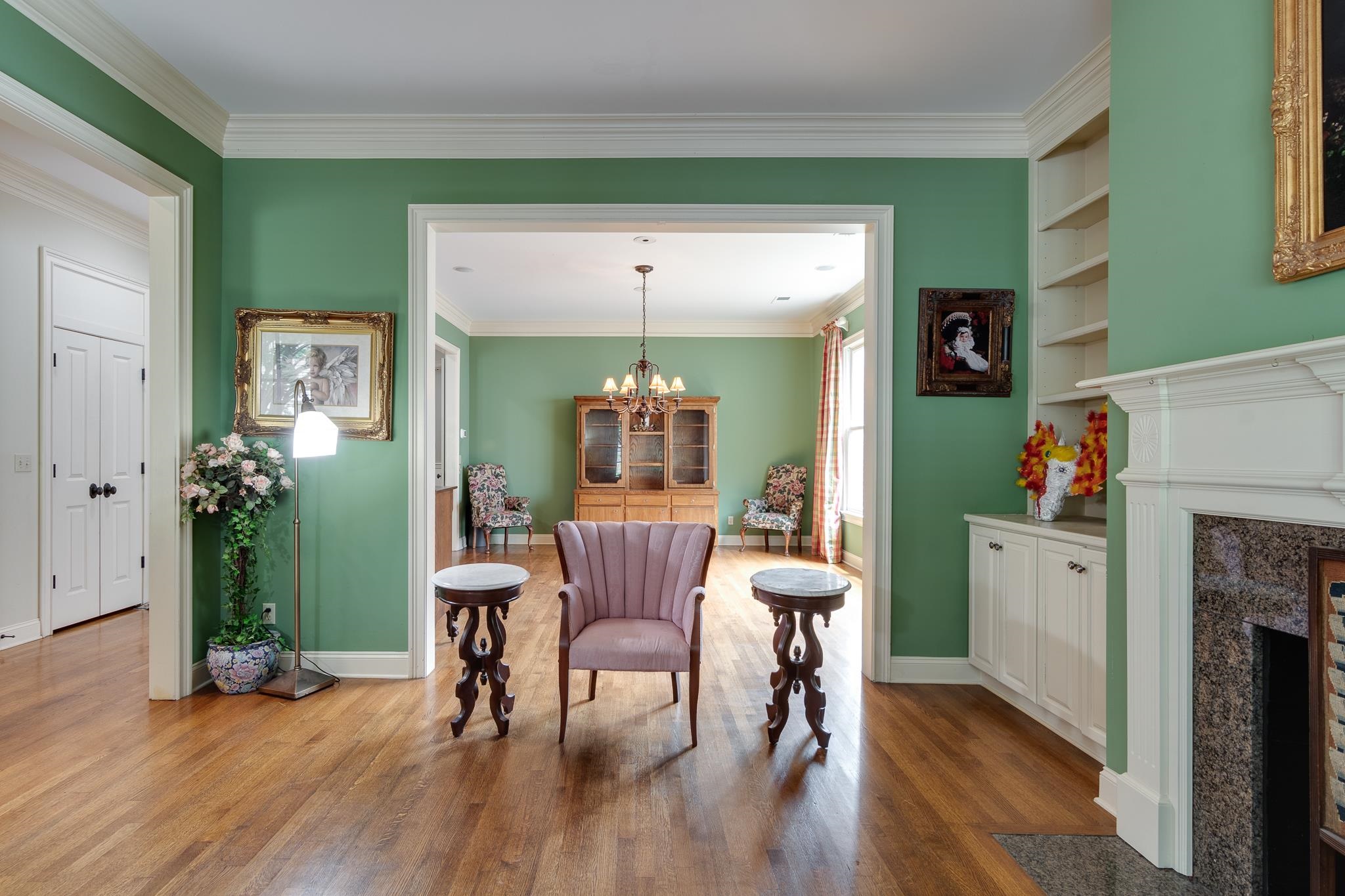 226 North White Station Road Memphis, TN 38117 - Photo 4 of 31 Sitting room featuring built in features, ornamental molding, hardwood / wood-style flooring, and a chandelier