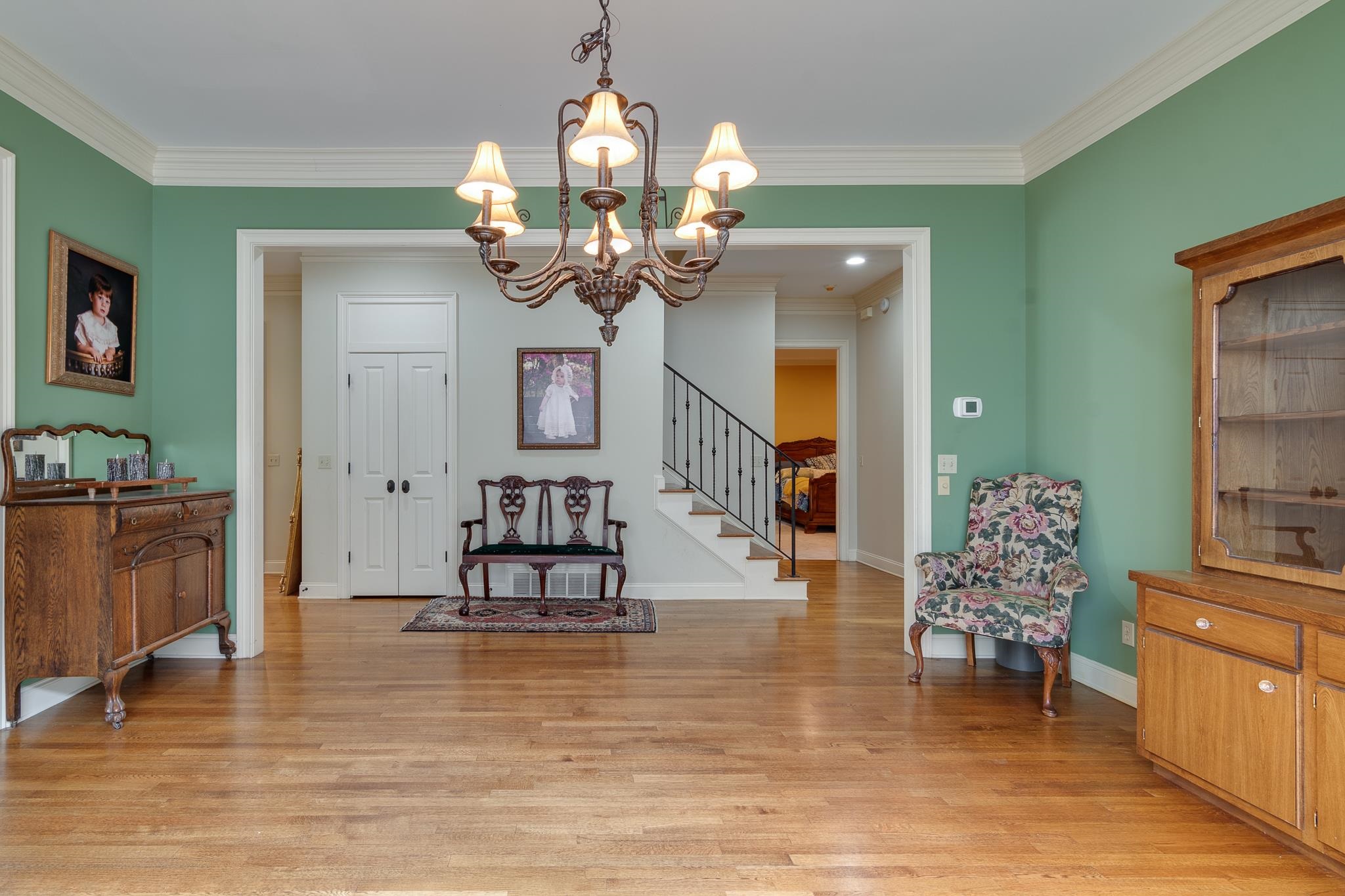 226 North White Station Road Memphis, TN 38117 - Photo 6 of 31 Interior space featuring light hardwood / wood-style floors, crown molding, and a chandelier