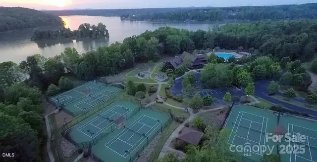 an aerial view of a house with outdoor space and a lake view