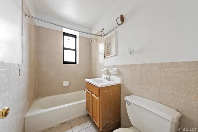 a bathroom with a sink a toilet and bathtub