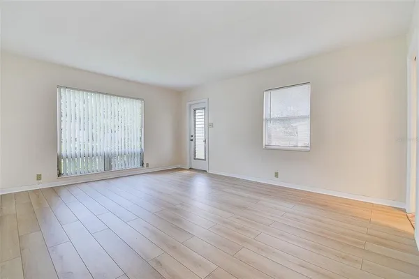 a view of room with hardwood floor and window