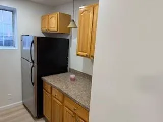 a kitchen with a refrigerator and cabinets