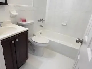 a bathroom with a sink toilet vanity and bathtub