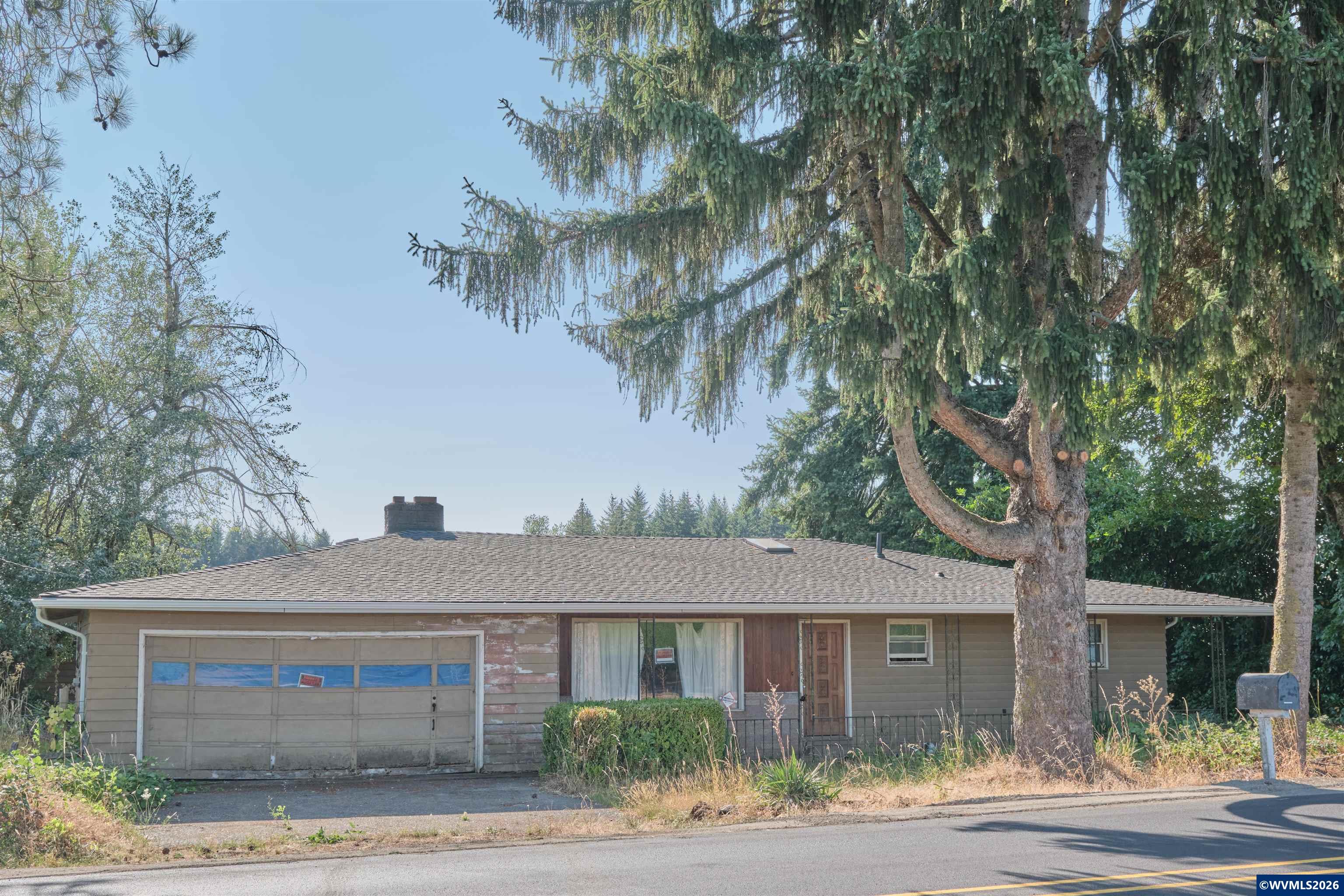 5495 Howell Prairie Road Southeast Aumsville, OR 97325 - Photo 15 of 22 a front view of a house with a garden