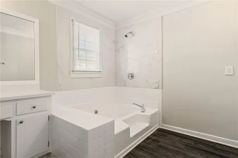 an empty room with ceiling fan and windows