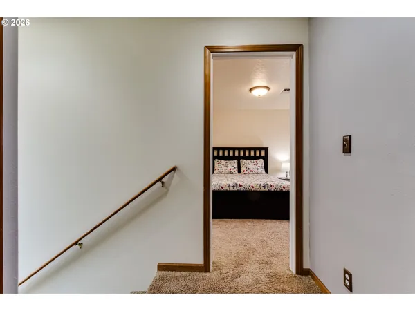 a bedroom with a bed and a painting on the wall