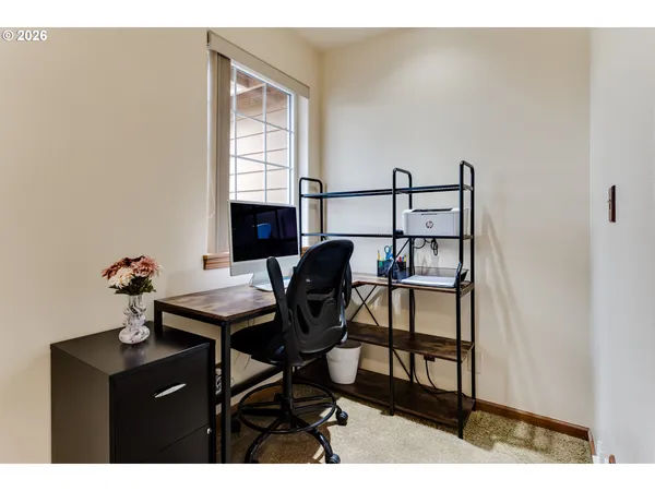 a bedroom with a bed and a dresser in it