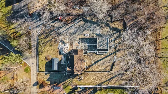 a view of a house with a yard covered in snow
