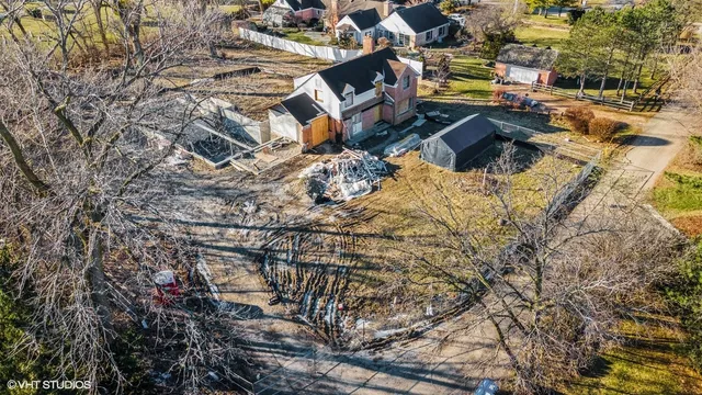 an aerial view of a houses with yard