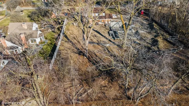 a view of a balcony with chairs and a potted plant