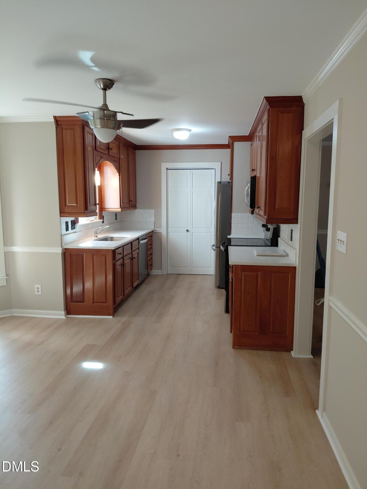 804 Olive Street Apex, NC 27502 - Photo 22 of 60 a large kitchen with a large counter top space and stainless steel appliances