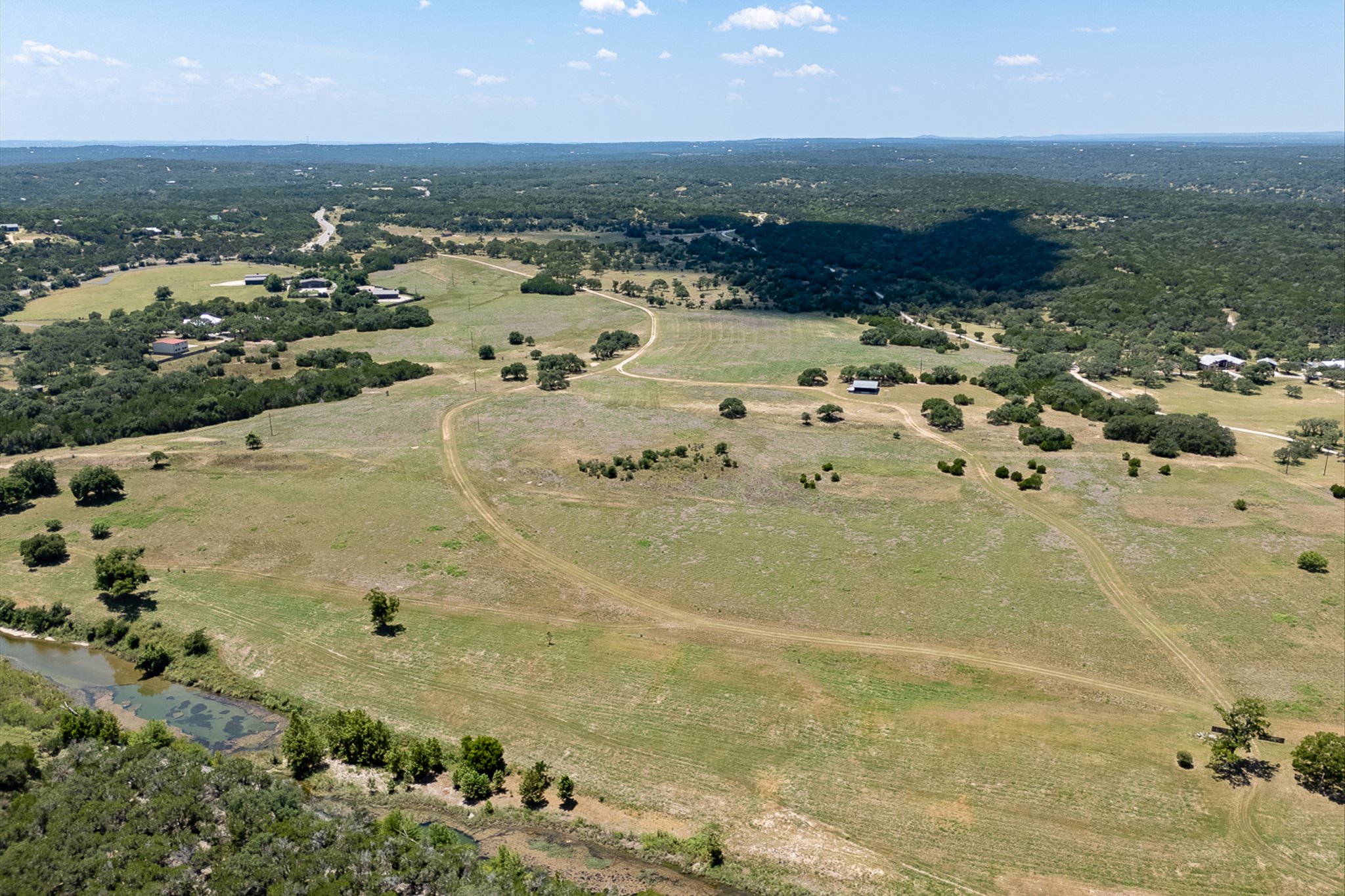 4698 Fischer Store Road Wimberley, TX 78676 - Photo 25 of 28 Gently rolling pastures meet the Blanco River on this expansive countryside acreage.