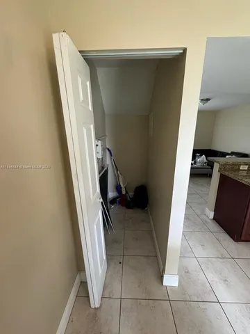 a view of a kitchen from a corridor