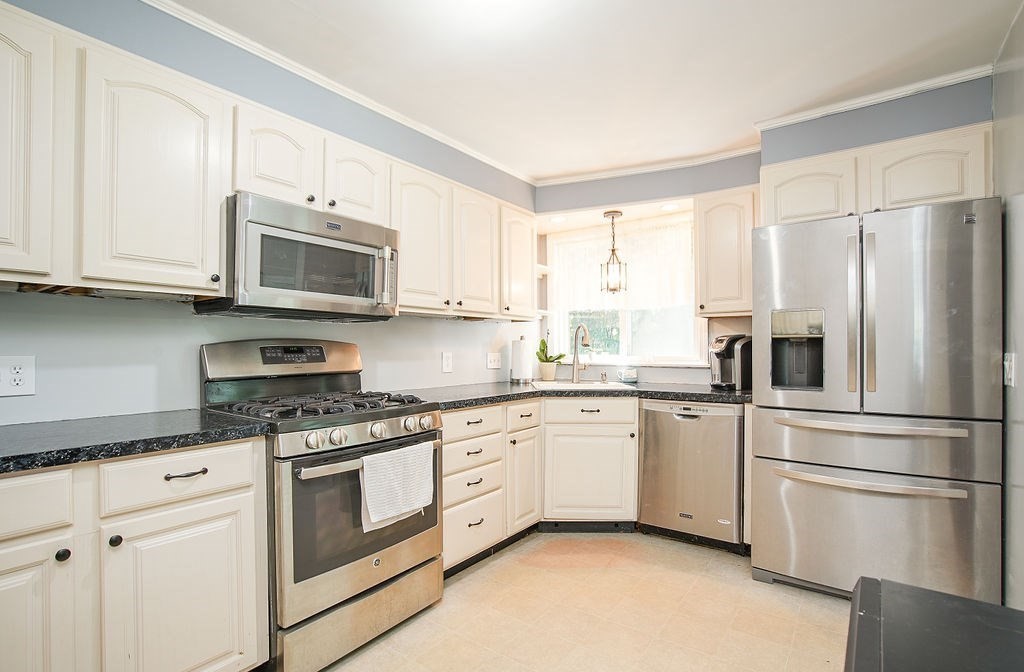 15 Holyoke Road Westfield, MA 01085 - Photo 12 of 41 a kitchen with stainless steel appliances granite countertop a refrigerator stove a sink and dishwasher with white cabinets