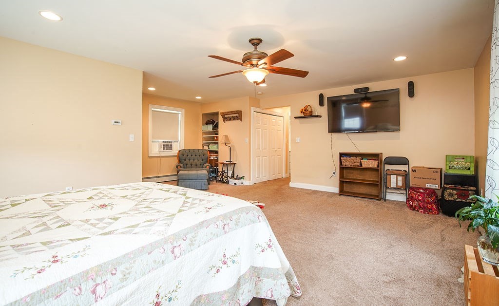15 Holyoke Road Westfield, MA 01085 - Photo 14 of 41 a spacious bedroom with a bed a dresser and a chandelier