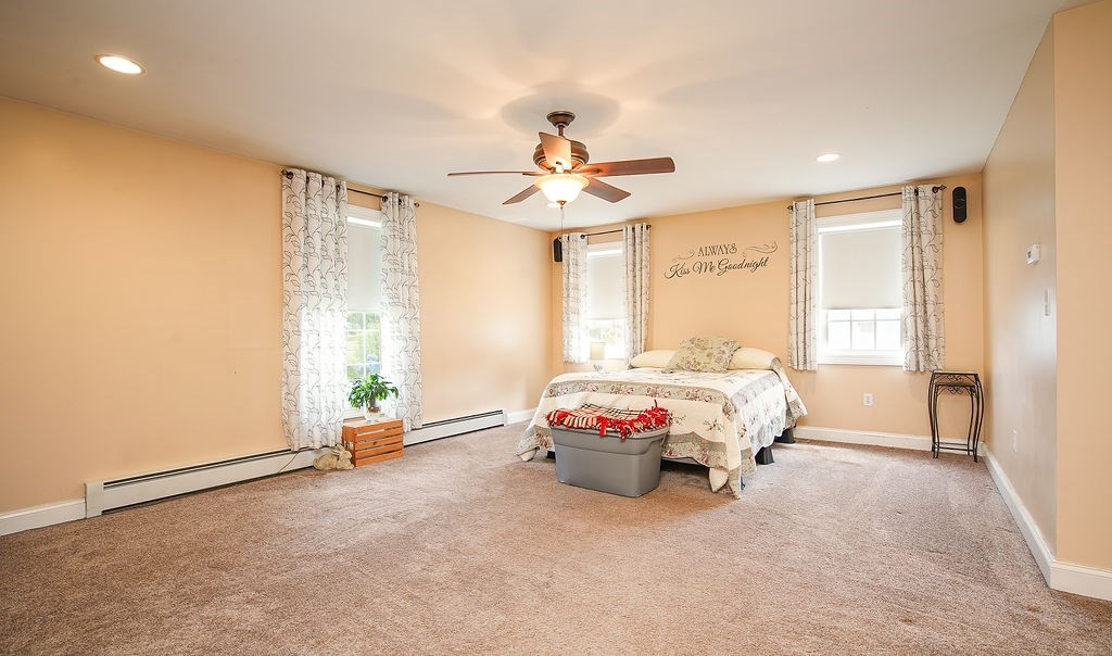 15 Holyoke Road Westfield, MA 01085 - Photo 15 of 41 a spacious bedroom with a bed and a chandelier