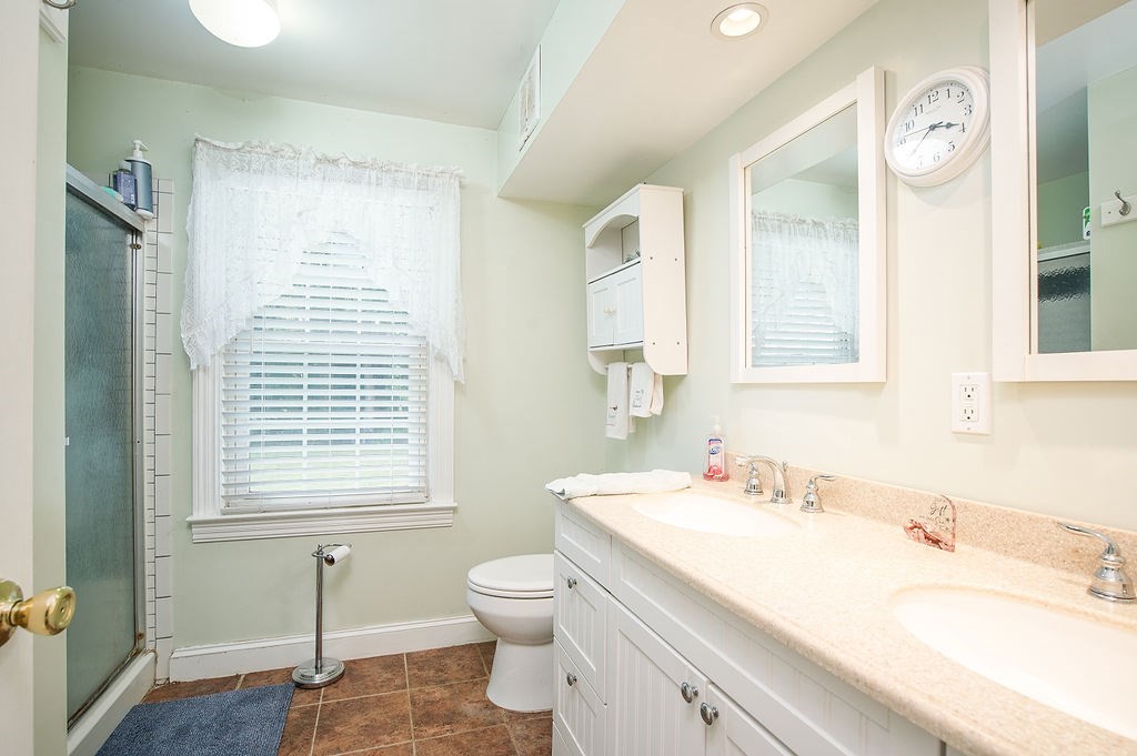 15 Holyoke Road Westfield, MA 01085 - Photo 16 of 41 a bathroom with a sink toilet a mirror and shower