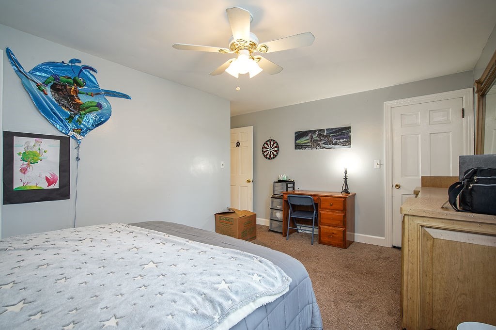 15 Holyoke Road Westfield, MA 01085 - Photo 19 of 41 a bedroom with a bed and a chandelier