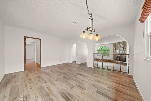 a view of a room with wooden floor fan and window