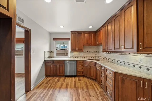 a kitchen with sink a stove and cabinets