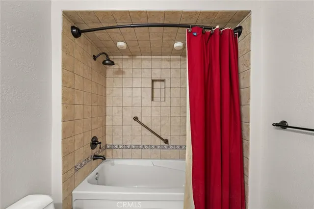 a bathroom with a bathtub and a shower