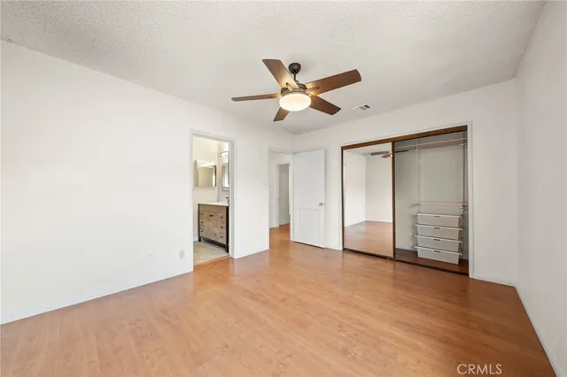 a view of an empty room with a ceiling fan