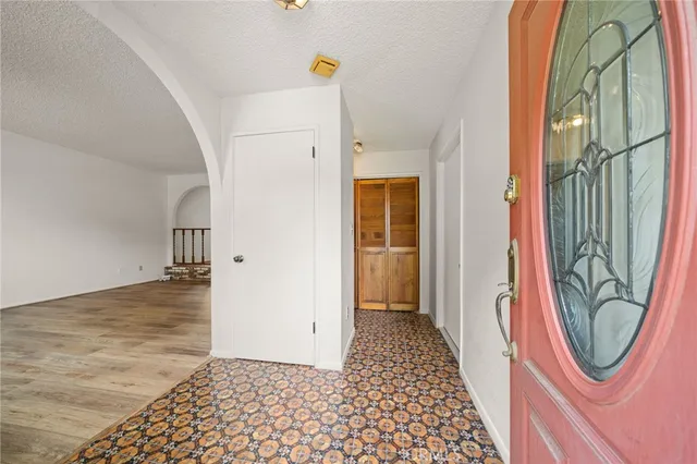 a view of a hallway with wooden floor and a dining table