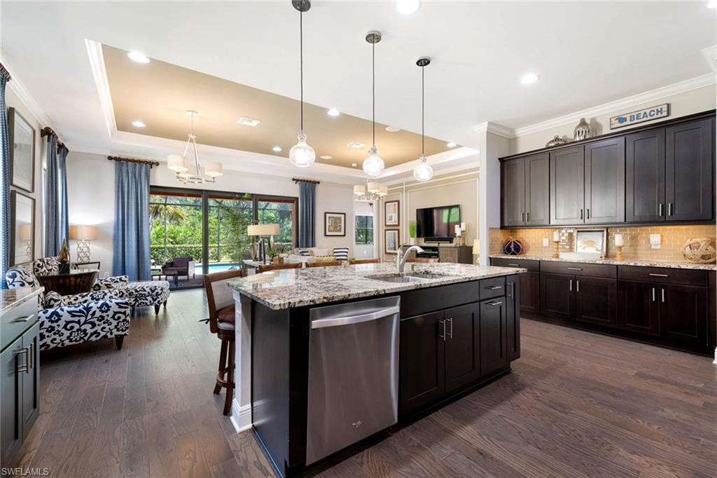 1229 Manado Drive Naples, FL 34113 - Photo 11 of 35 a kitchen with lots of counter space a sink appliances and living room view