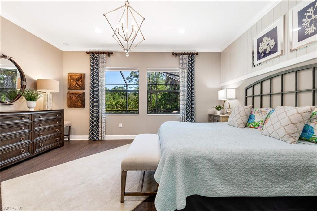 1229 Manado Drive Naples, FL 34113 - Photo 21 of 35 a bedroom with a large bed and a window