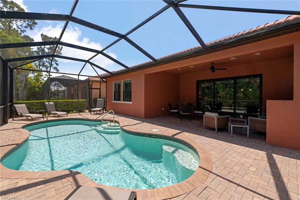 1229 Manado Drive Naples, FL 34113 - Photo 29 of 35 a view of a swimming pool with a patio