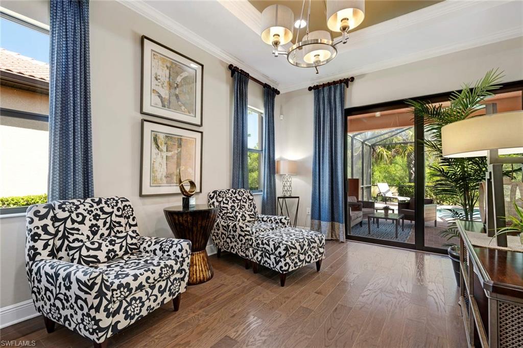 1229 Manado Drive Naples, FL 34113 - Photo 4 of 35 a bedroom with bed and wooden floor