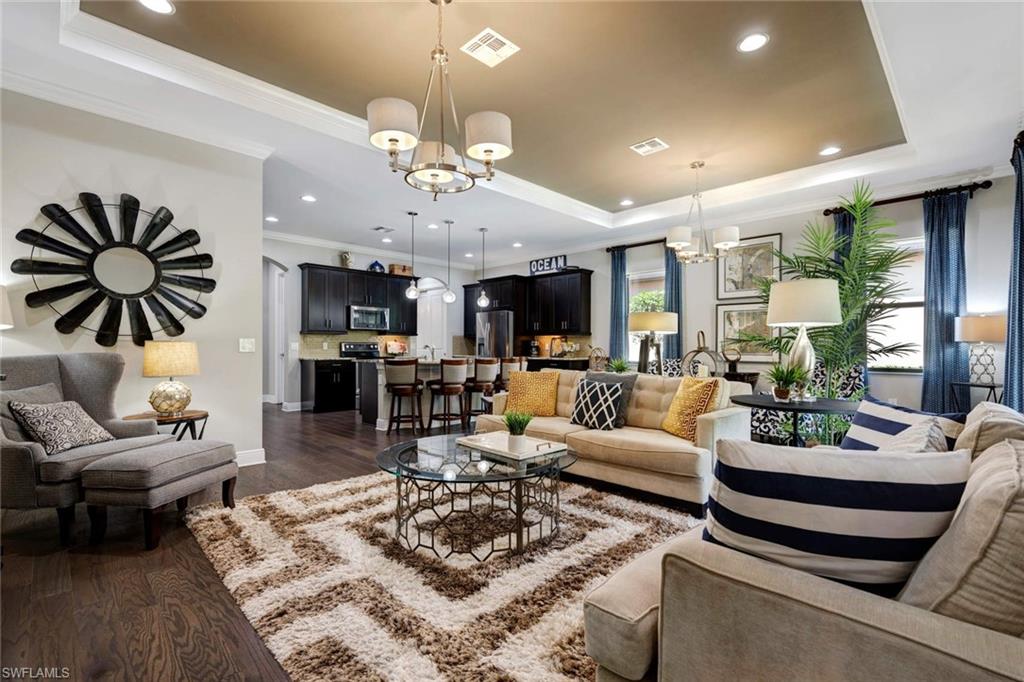 1229 Manado Drive Naples, FL 34113 - Photo 9 of 35 a living room with furniture potted plant and a chandelier