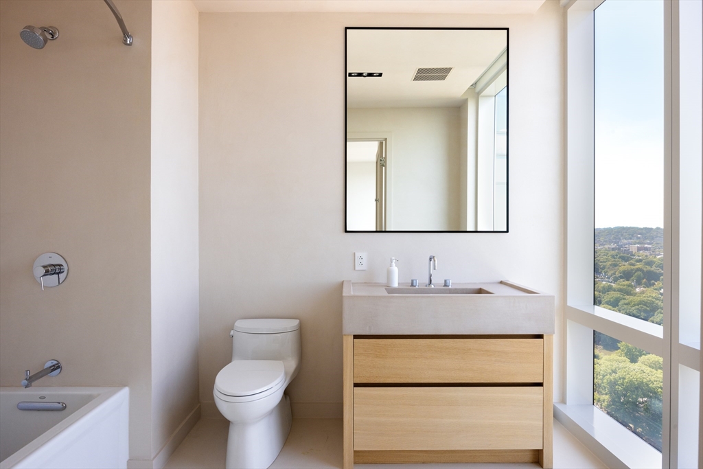 188 Brookline Avenue, Unit 27A/C Boston, MA 02215 - Photo 8 of 17 a bathroom with a toilet sink and mirror