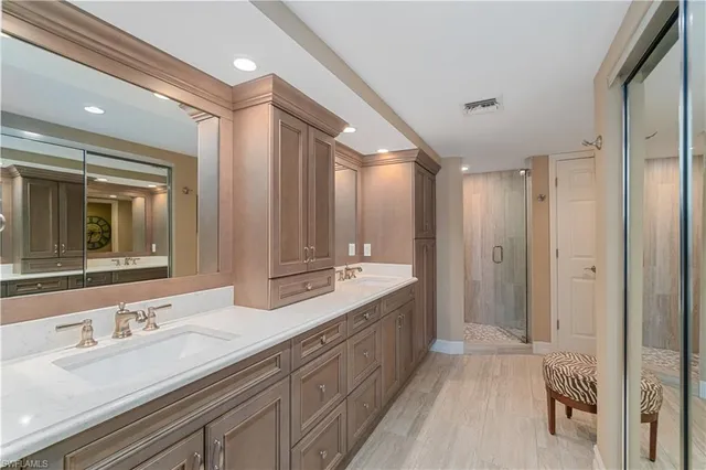 a bathroom with a double vanity sink mirror and double