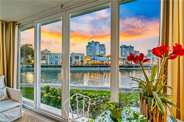 a view of a lake with a floor to ceiling windows with wooden floor