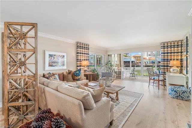 a living room with furniture and a floor to ceiling window