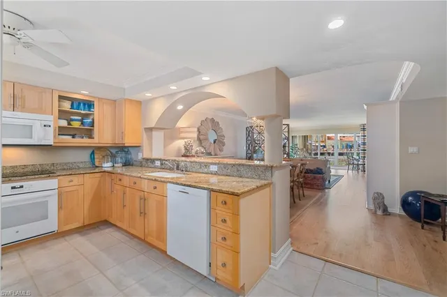 a kitchen with granite countertop a sink and cabinets