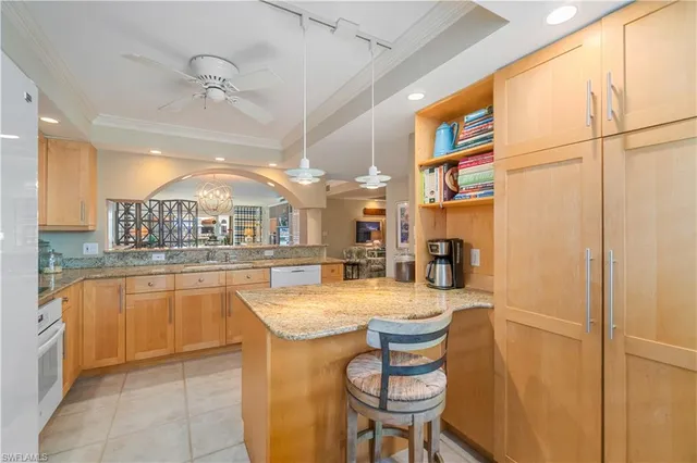 a room with granite countertop furniture and a kitchen view