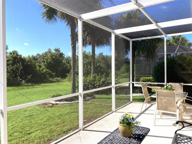 a view of porch with a table and chairs under an umbrella