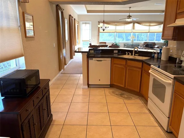 a kitchen with a sink a stove top oven a counter space and cabinets
