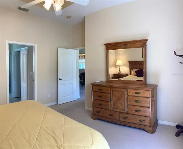 a bedroom with a bed and a dresser