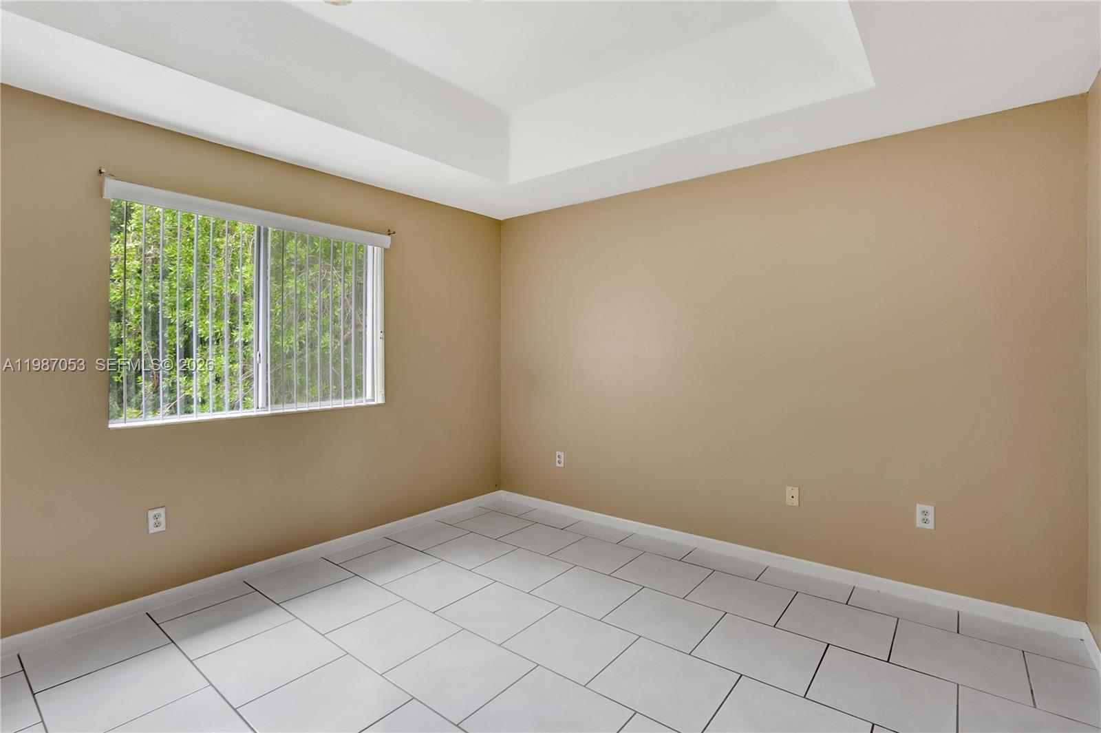 2874 Southeast 15th Road, Unit 52 Homestead, FL 33035 - Photo 13 of 16 a view of an empty room with a window