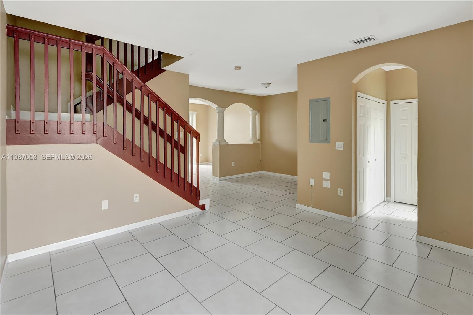 2874 Southeast 15th Road, Unit 52 Homestead, FL 33035 - Photo 2 of 16 a view of a hallway with entryway and stairs