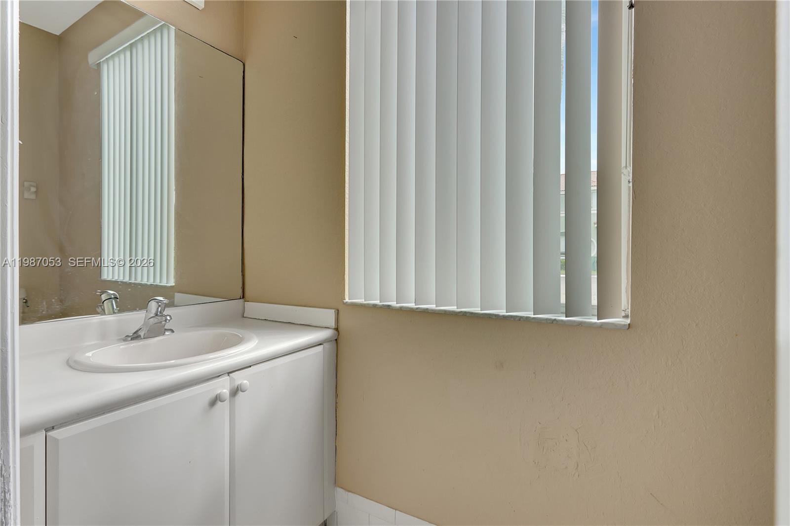 2874 Southeast 15th Road, Unit 52 Homestead, FL 33035 - Photo 4 of 16 a bathroom with a sink and a mirror