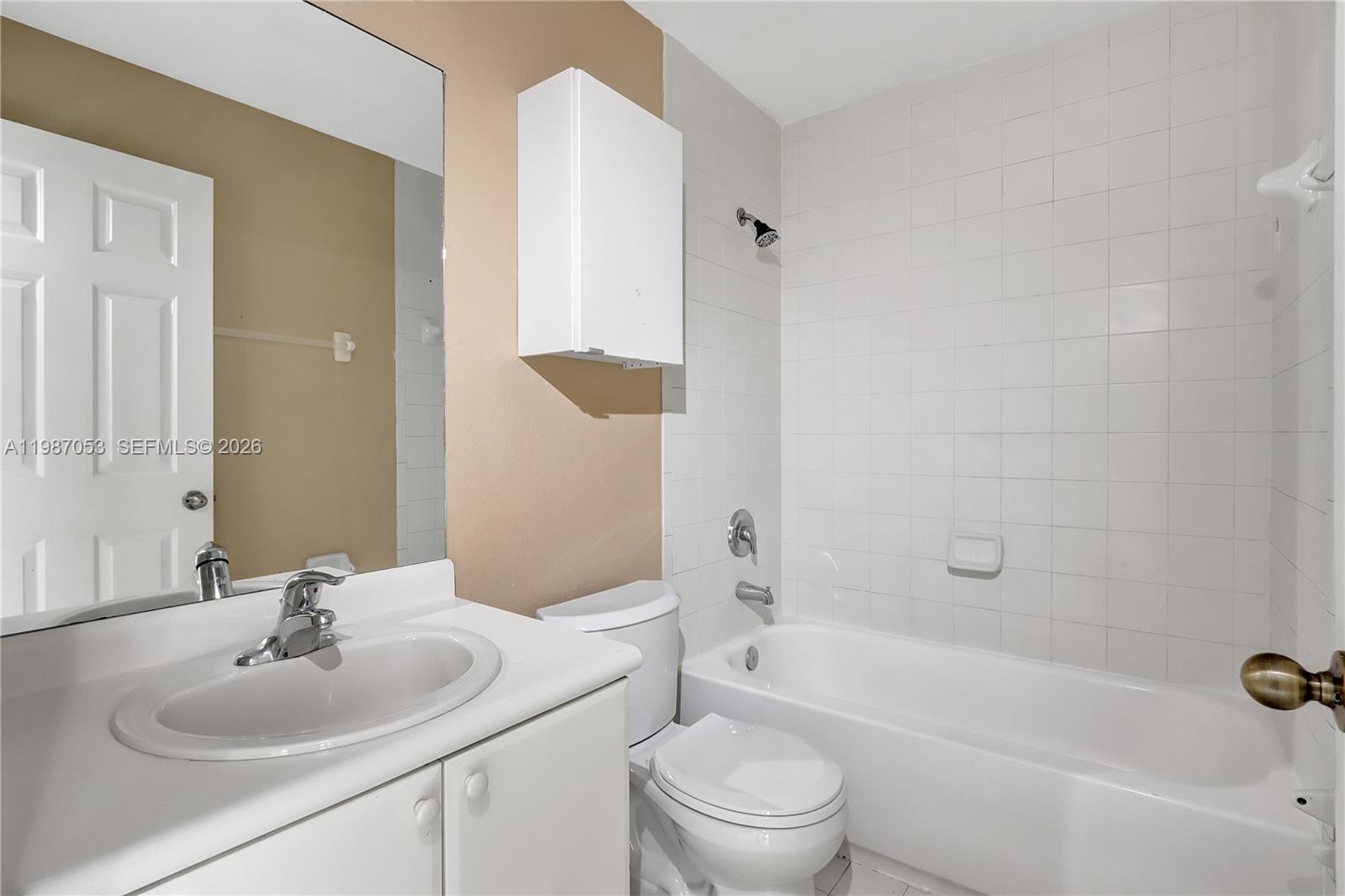 2874 Southeast 15th Road, Unit 52 Homestead, FL 33035 - Photo 9 of 16 a bathroom with a sink toilet and shower