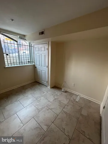 an empty room with a empty space and windows