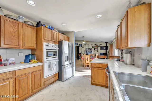 a kitchen with stainless steel appliances granite countertop a refrigerator and a sink