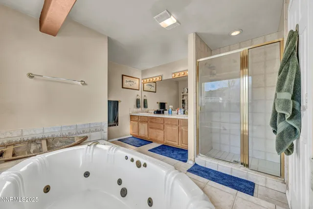 a bathroom with a tub a sink and a shower