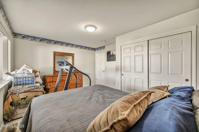 a bedroom with two beds and a chandelier